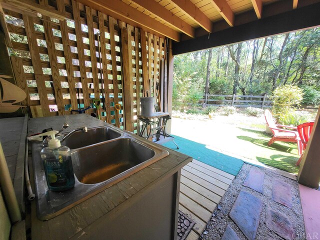 view of patio featuring fence and a sink