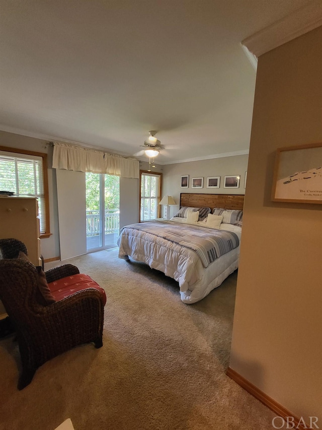 carpeted bedroom featuring a ceiling fan, access to outside, baseboards, and crown molding