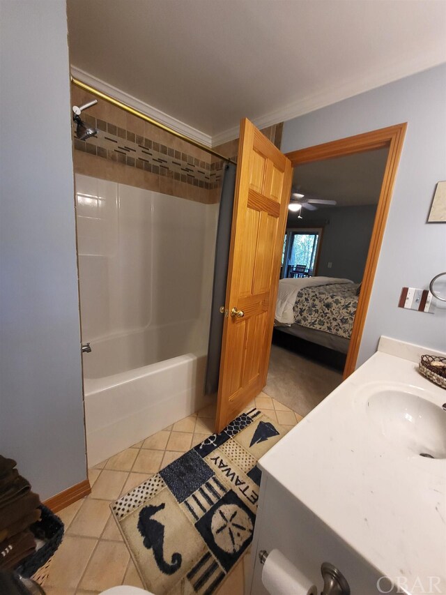 ensuite bathroom with shower / tub combination, a sink, tile patterned floors, ensuite bath, and crown molding