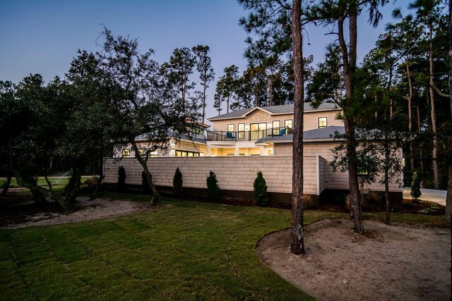 view of yard featuring a balcony and fence