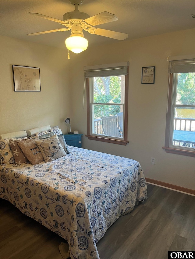 bedroom featuring ceiling fan, baseboards, and wood finished floors