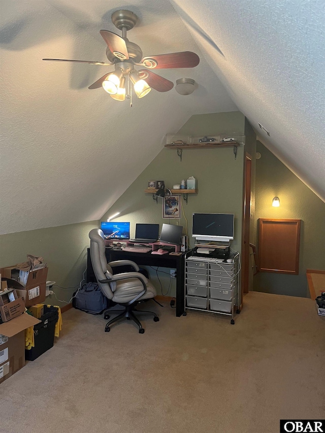 carpeted office space with ceiling fan, vaulted ceiling, and a textured ceiling