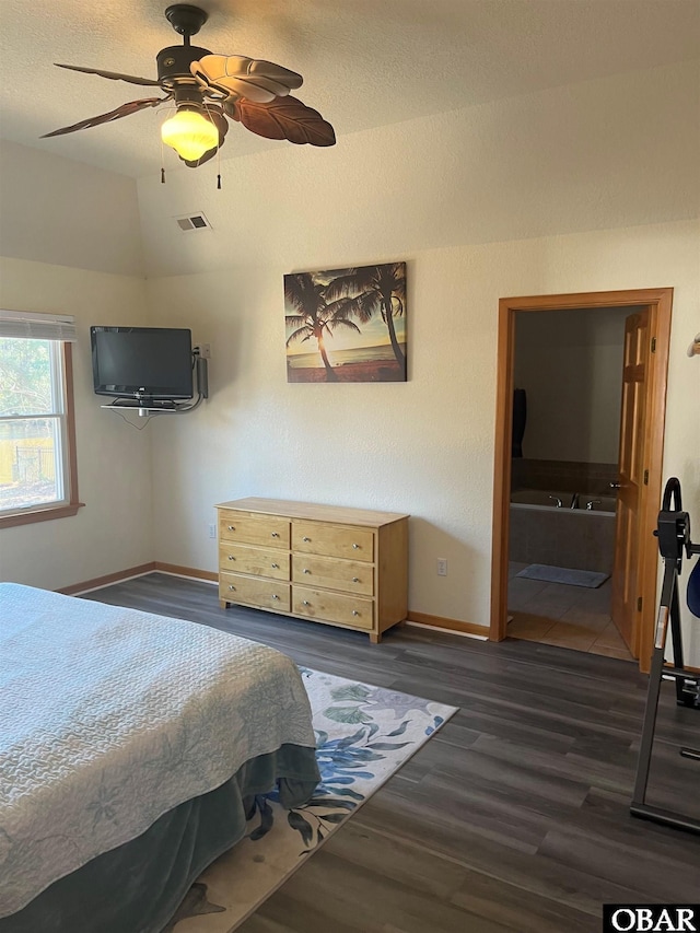 bedroom with baseboards, visible vents, a ceiling fan, wood finished floors, and vaulted ceiling