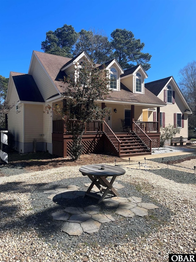 view of front facade with stairway and a porch