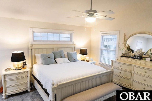 bedroom featuring dark wood-type flooring, lofted ceiling, and ceiling fan