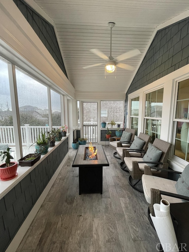 sunroom with lofted ceiling, plenty of natural light, and a mountain view