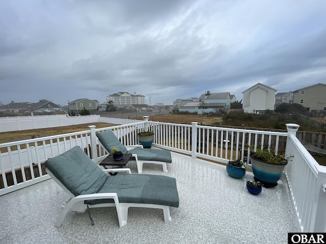 exterior space featuring a residential view and fence