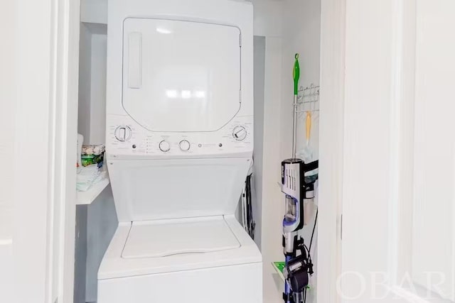 laundry area featuring laundry area and stacked washer and clothes dryer