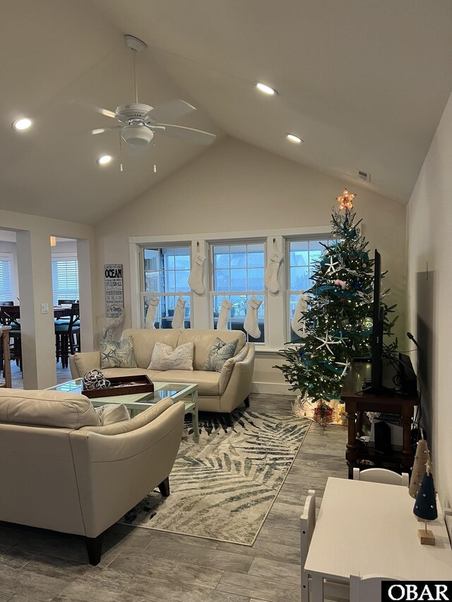 living room featuring ceiling fan, high vaulted ceiling, wood finished floors, and recessed lighting