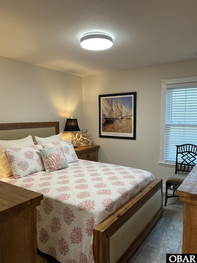 bedroom with dark wood finished floors