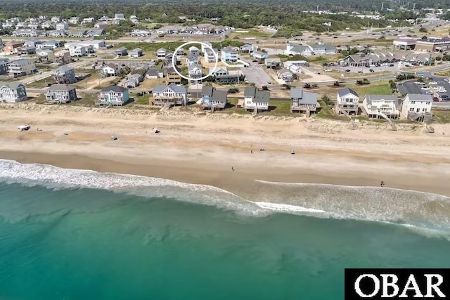 birds eye view of property with a water view, a residential view, and a view of the beach