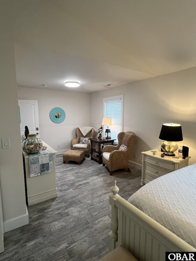 bedroom with baseboards and dark wood-style flooring