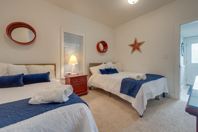 bedroom featuring light carpet and baseboards