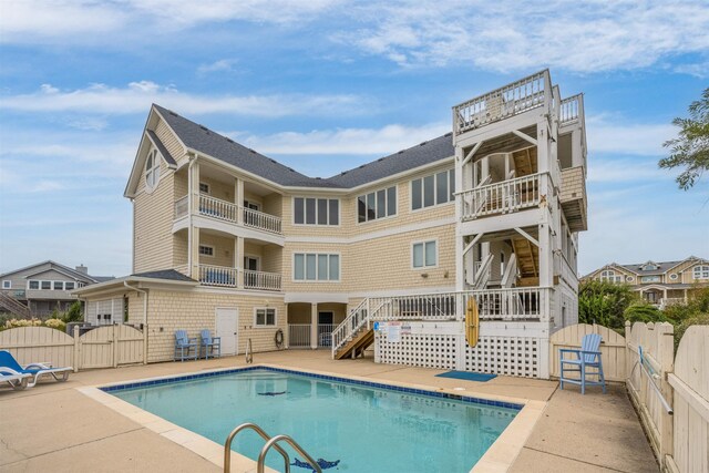 view of pool with a fenced in pool, stairway, a gate, fence, and a patio area