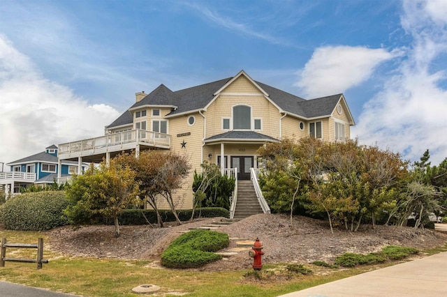 view of front of property featuring roof with shingles