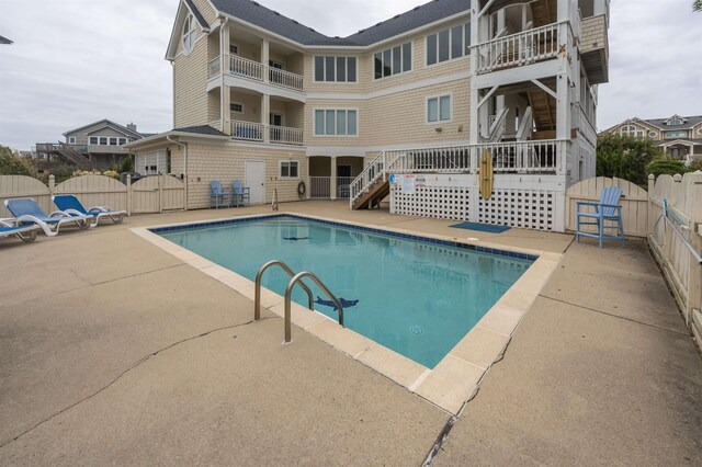 view of swimming pool featuring a fenced in pool, a gate, a patio area, and fence