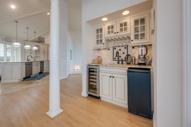 bar featuring wine cooler, a sink, decorative columns, and stainless steel dishwasher