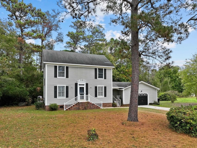 colonial-style house with a garage, crawl space, a shingled roof, and a front lawn