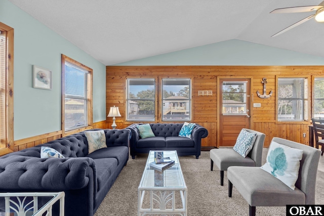 living room featuring a wealth of natural light, carpet floors, and vaulted ceiling