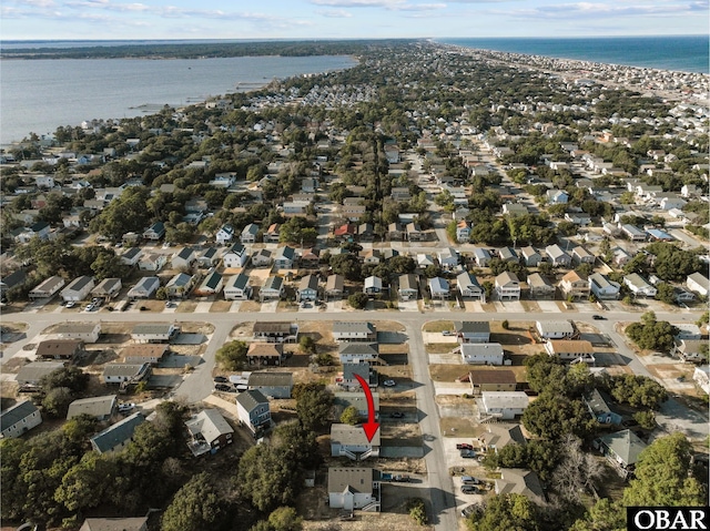 drone / aerial view featuring a residential view and a water view