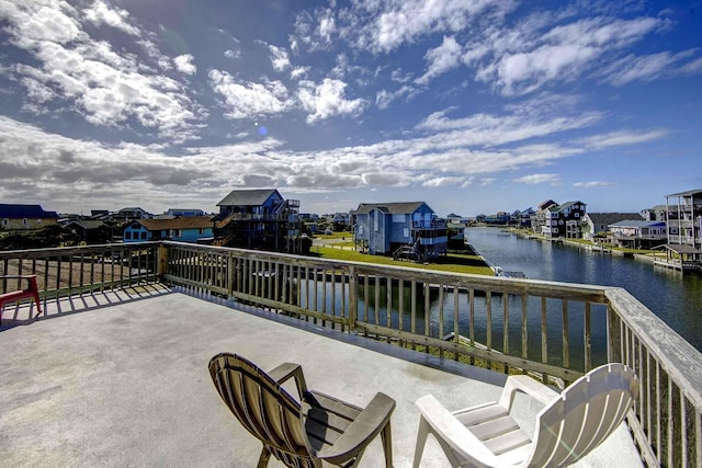view of patio / terrace featuring a residential view and a water view