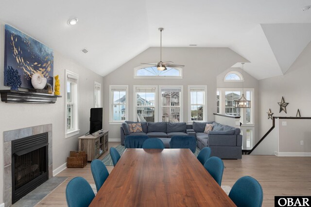 57241 Summerplace Dr Lot 28, Hatteras, NC 27943 - dining space with ceiling fan, light wood-type flooring, vaulted ceiling, a tile fireplace, and baseboards