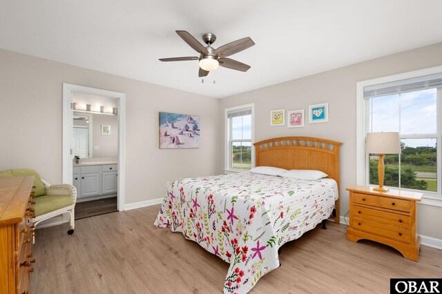 57241 Summerplace Dr Lot 28, Hatteras, NC 27943 - bedroom featuring light wood-style flooring, baseboards, a ceiling fan, and connected bathroom