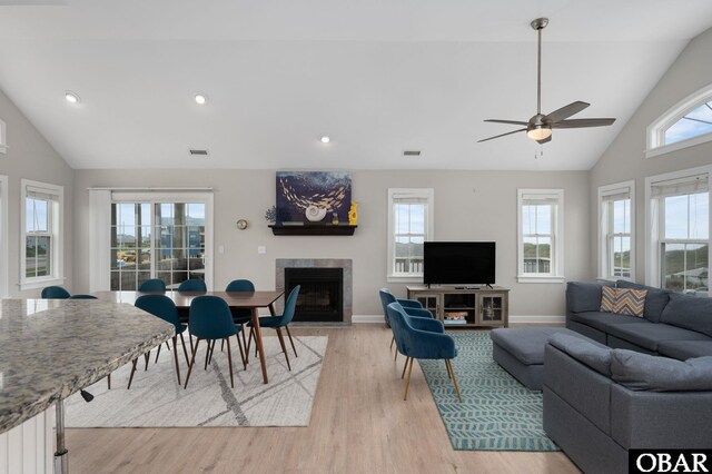 57241 Summerplace Dr Lot 28, Hatteras, NC 27943 - living area featuring a tile fireplace, light wood-style flooring, a ceiling fan, baseboards, and high vaulted ceiling