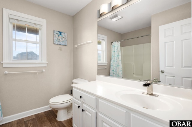 57241 Summerplace Dr Lot 28, Hatteras, NC 27943 - bathroom featuring baseboards, wood finished floors, plenty of natural light, and toilet