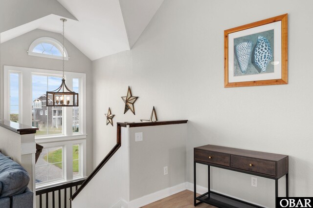 57241 Summerplace Dr Lot 28, Hatteras, NC 27943 - hall with lofted ceiling, a chandelier, wood finished floors, and an upstairs landing