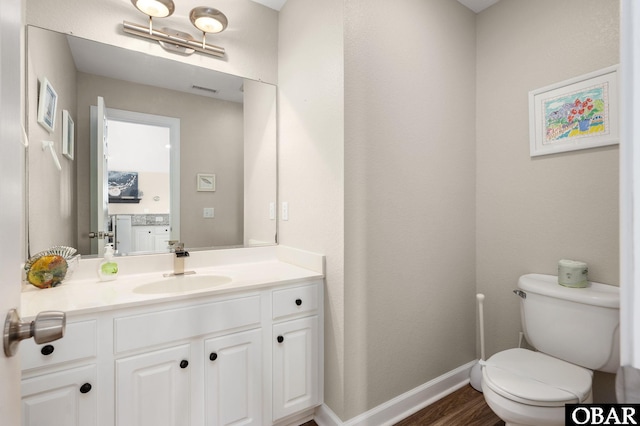 57241 Summerplace Dr Lot 28, Hatteras, NC 27943 - half bathroom with toilet, vanity, wood finished floors, and baseboards