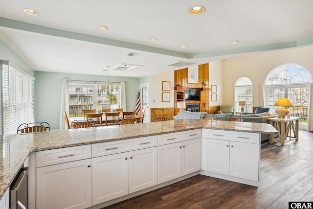 135 Ships Watch Dr Lot 32, Duck, NC 27949 - kitchen with wainscoting, dark wood finished floors, light stone counters, recessed lighting, and white cabinetry
