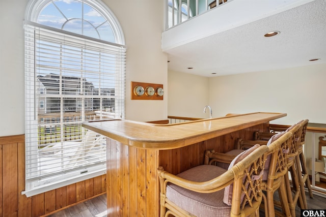 135 Ships Watch Dr Lot 32, Duck, NC 27949 - indoor wet bar featuring wainscoting, wood finished floors, and a textured ceiling