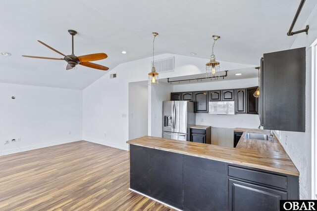 113 B And B Ln, Coinjock, NC 27923 - kitchen featuring stainless steel fridge with ice dispenser, white microwave, lofted ceiling, ceiling fan, and a peninsula