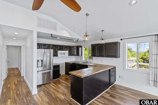 113 B And B Ln, Coinjock, NC 27923 - kitchen with stainless steel fridge, white microwave, vaulted ceiling, ceiling fan, and a peninsula