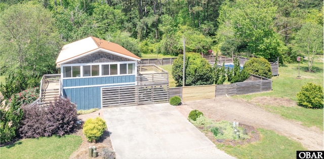 113 B And B Ln, Coinjock, NC 27923 - view of front of house with stairs, board and batten siding, driveway, a forest view, and a wooden deck
