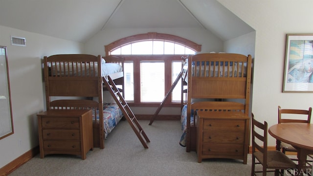 bedroom featuring vaulted ceiling, baseboards, visible vents, and light colored carpet