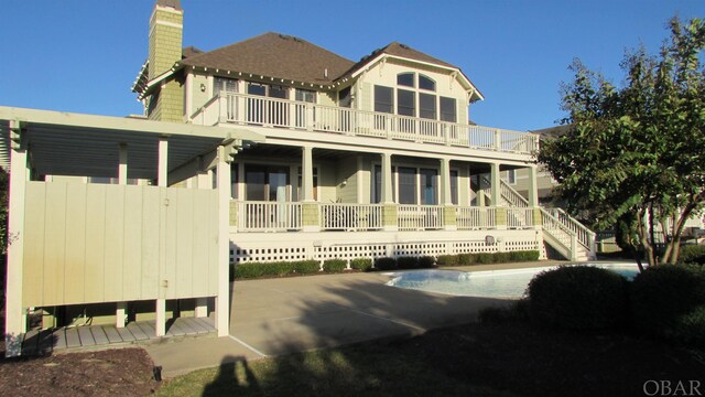744 Hammock Ln Lot 342, Corolla, NC 27927 - rear view of property featuring a chimney and a balcony