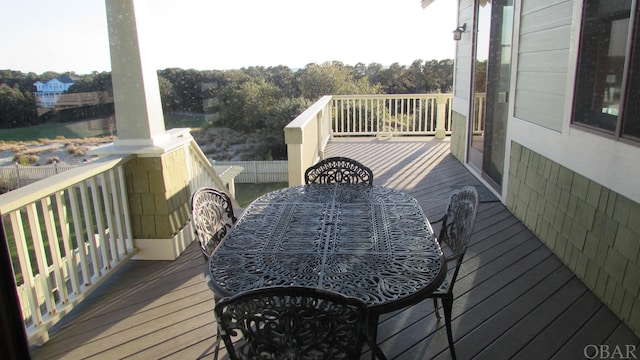 wooden terrace featuring outdoor dining area