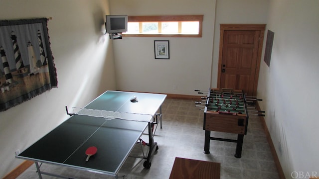 game room with baseboards and tile patterned floors