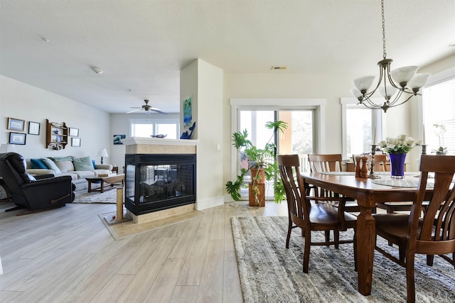 dining room with a healthy amount of sunlight, visible vents, and light wood-style flooring