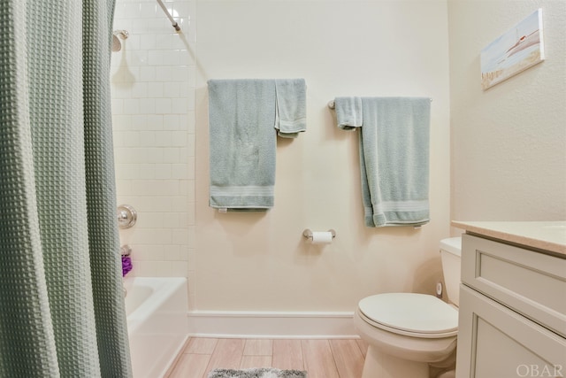 bathroom featuring baseboards, toilet, wood tiled floor, shower / bathtub combination with curtain, and vanity