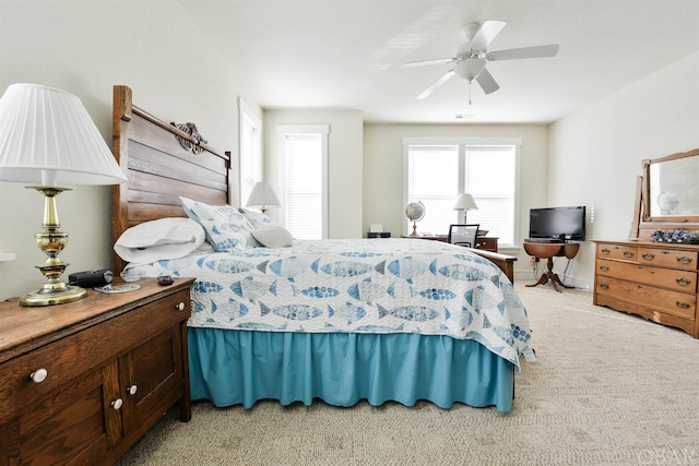 bedroom featuring light carpet, ceiling fan, and baseboards