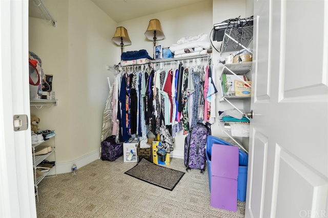 walk in closet with carpet flooring