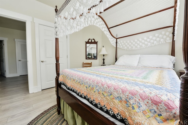 bedroom with baseboards and light wood finished floors