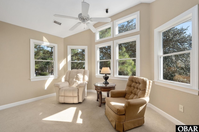 living area with ceiling fan, lofted ceiling, light carpet, visible vents, and baseboards