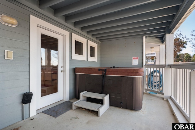 view of patio / terrace featuring a balcony and a hot tub