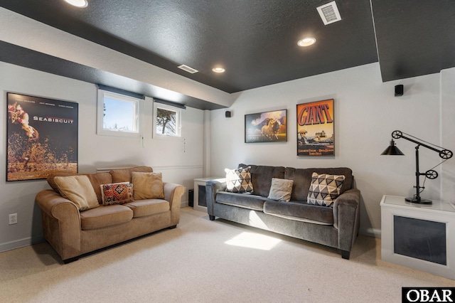 carpeted cinema room featuring baseboards, visible vents, a textured ceiling, and recessed lighting