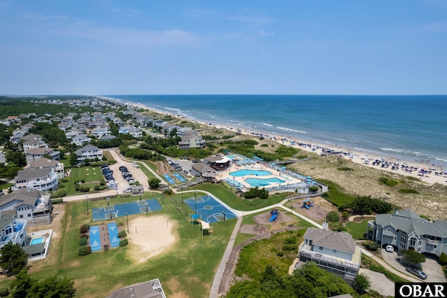 birds eye view of property with a beach view, a residential view, and a water view