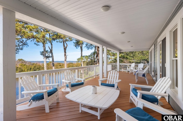 wooden terrace featuring a water view